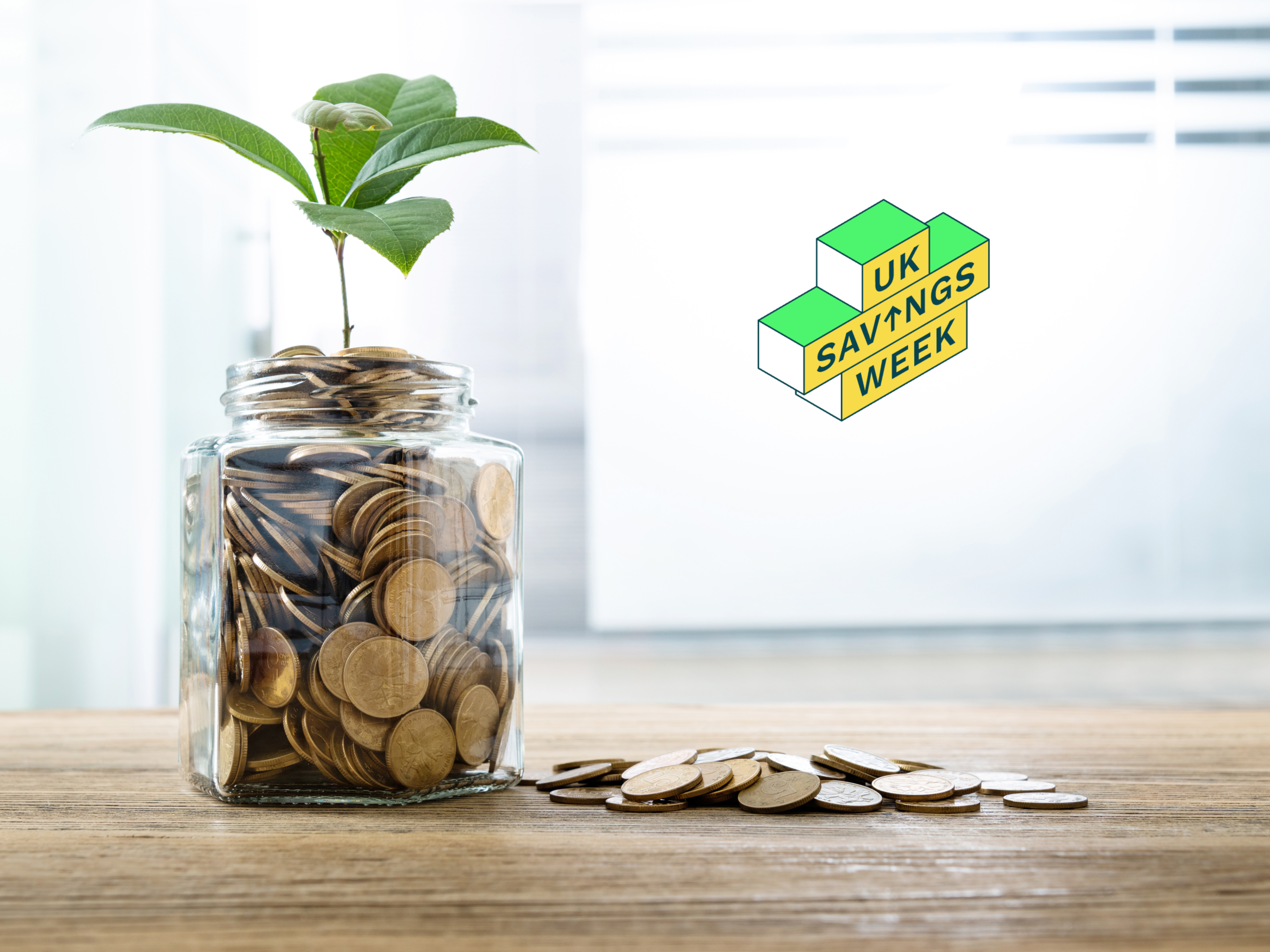 Jar filled with coins with a plant growing from the top. UK Savings Week logo added to the design.